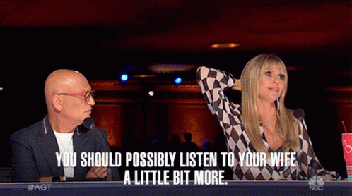 Man And Woman Sitting At Microphones Saying You Should Possibly Listen To Your Wife GIF