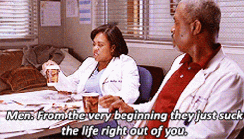 Man And Woman Sitting At Table GIF