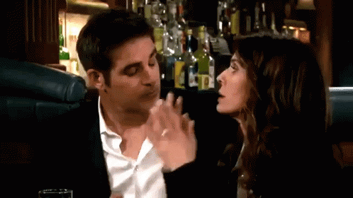 Man And Woman Sitting At Table In Bar GIF