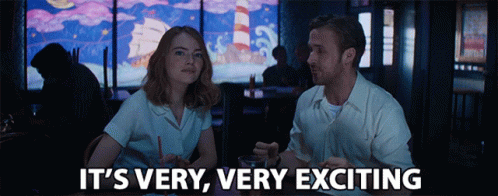 Man And Woman Sitting At Table Saying It's Very Very Exciting GIF