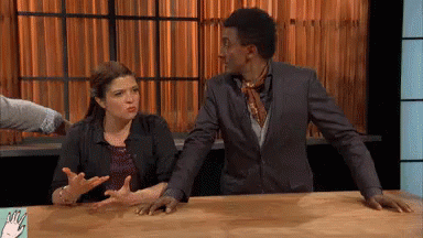 Man and Woman Sitting at Table With Hands