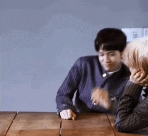 Man and Woman Sitting at Wooden Table Talking