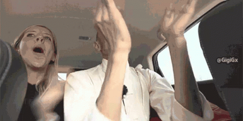 Man And Woman Sitting In Car With Arms In Air GIF