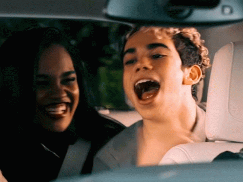 Man and Woman Sitting in Car With Mouths Open