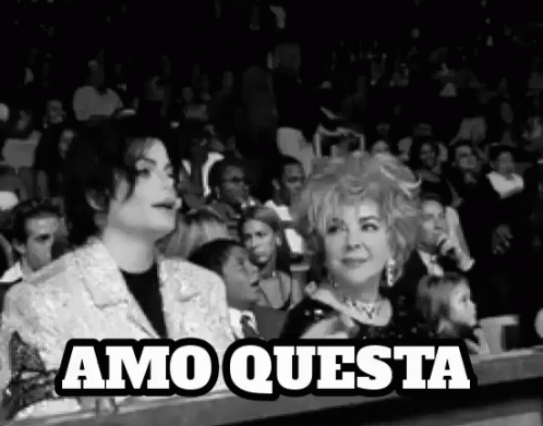 Man and Woman Sitting in Crowd