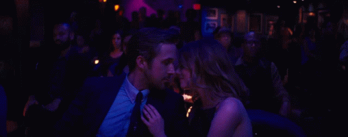 Man And Woman Sitting In Dark Room GIF
