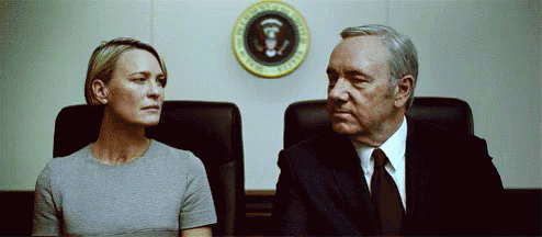 Man and Woman Sitting in Front of President Seal