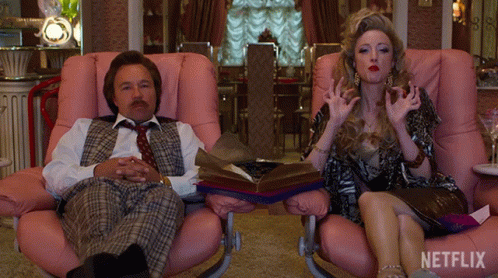 Man and Woman Sitting in Pink Chairs