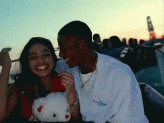 Man and Woman Sitting Next to Hello Kitty