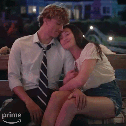Man And Woman Sitting On Bench With Amazon Prime Arrow GIF