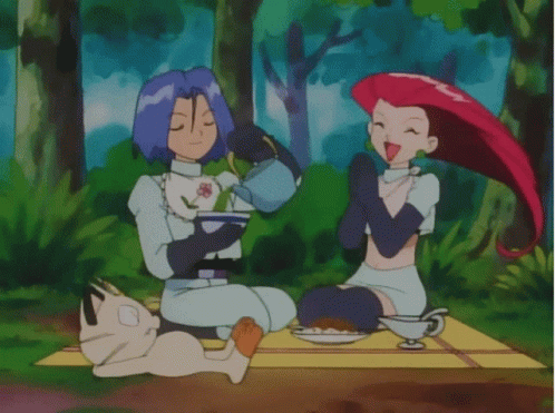 Man and Woman Sitting on Blanket Eating