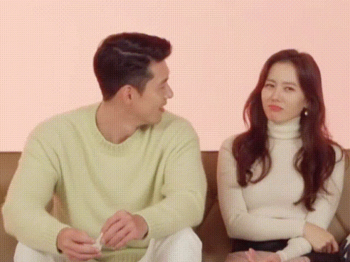 Man And Woman Sitting On Couch GIF