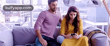 Man and Woman Sitting on Couch