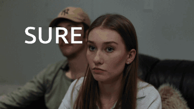 Man And Woman Sitting On Couch Saying Sure GIF