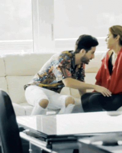 Man and Woman Sitting on Couch Talking