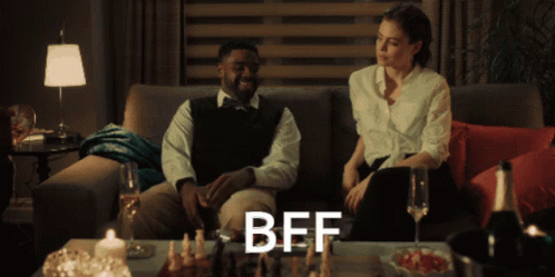 Man and Woman Sitting on Couch with BFF on Table