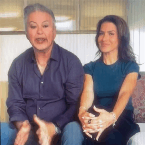 Man and Woman Sitting on Couch With Hands Folded