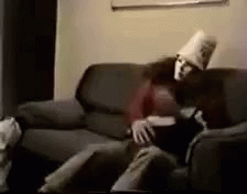 Man And Woman Sitting On Couch With Pillow On Head GIF