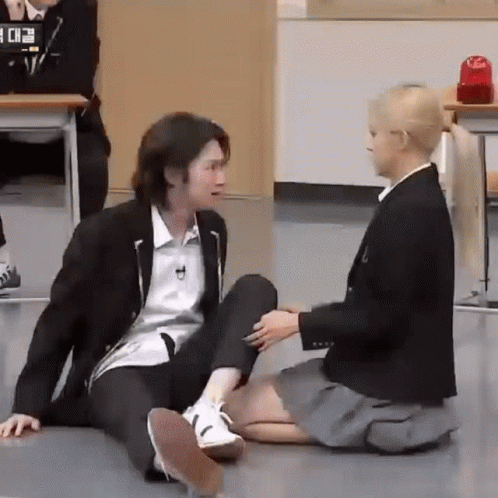 Man and Woman Sitting on Floor Holding Hands