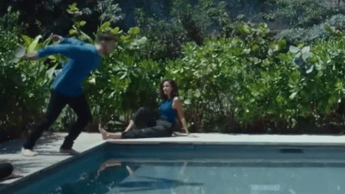 Man and Woman Sitting Pool Edge