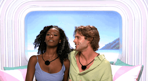 Man And Woman Sitting Smiling GIF