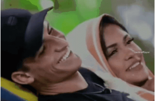 Man and Woman Sitting Smiling Woman Wearing Hijab