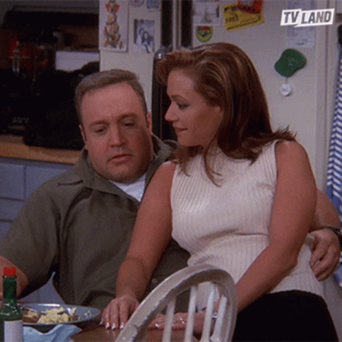 Man and Woman Sitting With TV Land Logo on Fridge