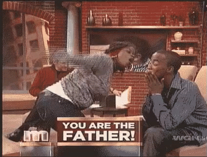 Man and Woman Sitting with You Are The Father Sign