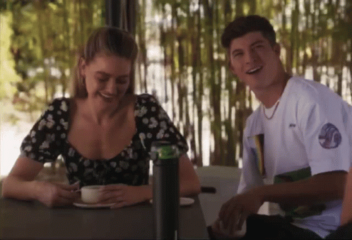 Man and Woman Smiling at Table