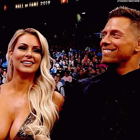 Man and Woman Smiling in Crowd