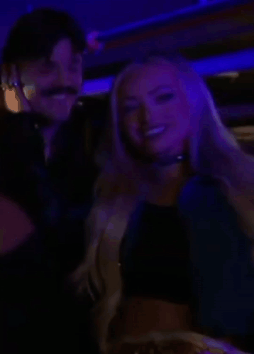 Man And Woman Smiling In Dark Room GIF