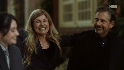 Man and Woman Smiling in Front of HBO Building