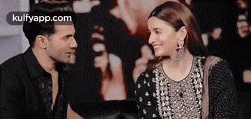 Man And Woman Smiling Sitting Together GIF