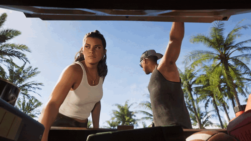 Man and Woman Standing in Back of Car
