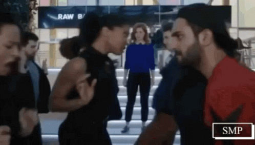 Man And Woman Standing In Crowded Area GIF