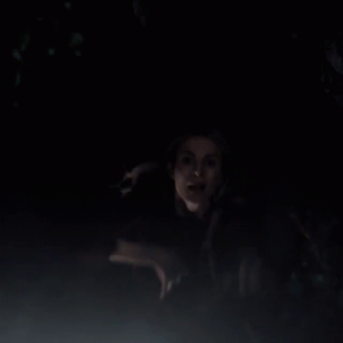 Man and Woman Standing in Dark Looking at Something