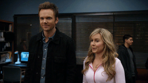 Man And Woman Standing In Dark Room GIF
