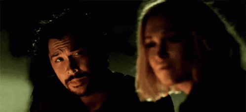 Man and Woman Standing in Darkness