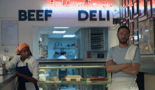 Man and Woman Standing in Front of Beef Deli