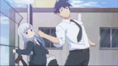 Man And Woman Standing In Front Of Building GIF