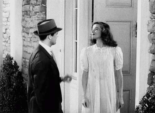 Man and Woman Standing in Front of Door