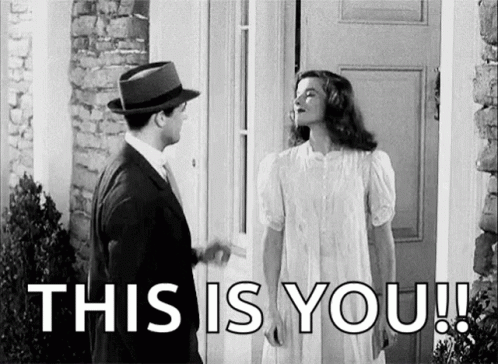 Man and Woman Standing in Front of Door Woman in White Dress and Hat