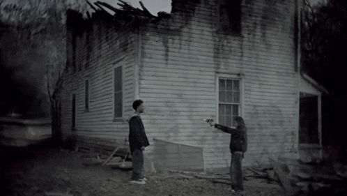 Man And Woman Standing In Front Of House GIF