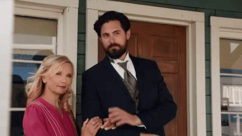 Man and Woman Standing in Front of House