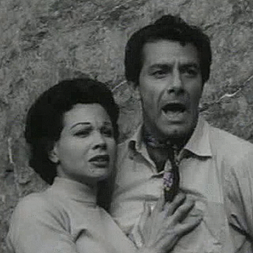 Man and Woman Standing in Front of Stone Wall