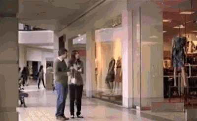 Man And Woman Standing In Mall GIF