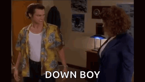 Man and Woman Standing in Room Man in Yellow Shirt