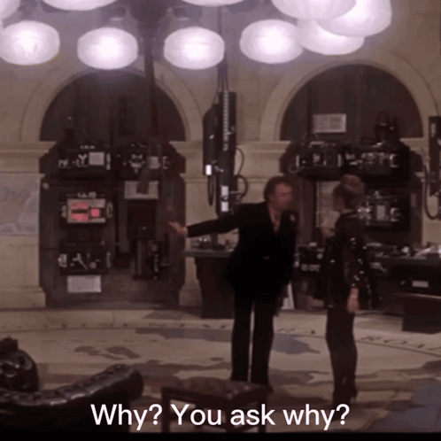 Man and Woman Standing in Room With Why You Ask Why