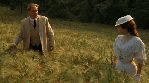 Man and Woman Standing in Tall Grass
