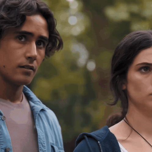Man And Woman Standing Looking At Camera GIF